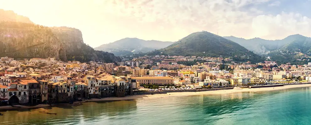 Italian coastline town with mountain backdrop